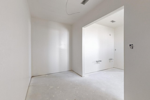 unfurnished room featuring visible vents