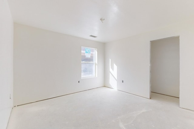 spare room featuring visible vents and concrete floors