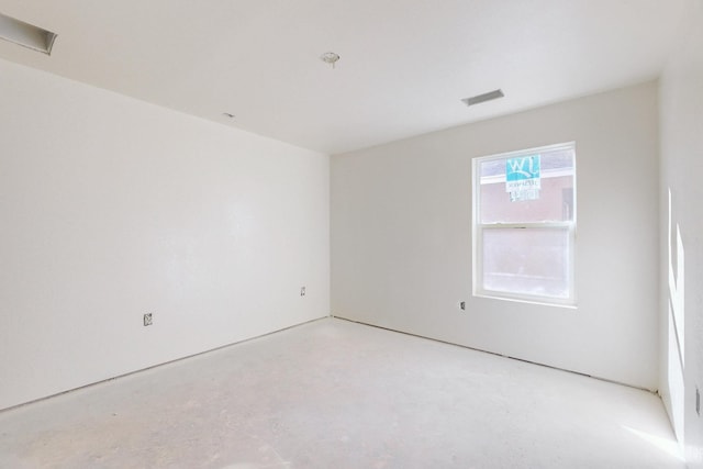unfurnished room with visible vents and concrete floors