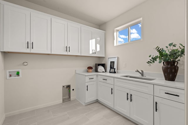 laundry area featuring washer hookup, sink, cabinets, and electric dryer hookup