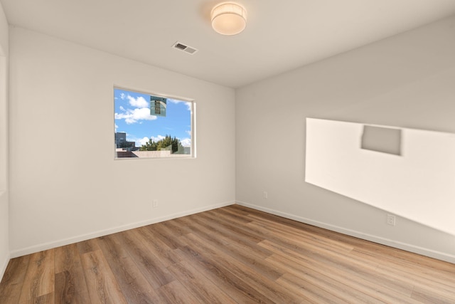 empty room with hardwood / wood-style flooring