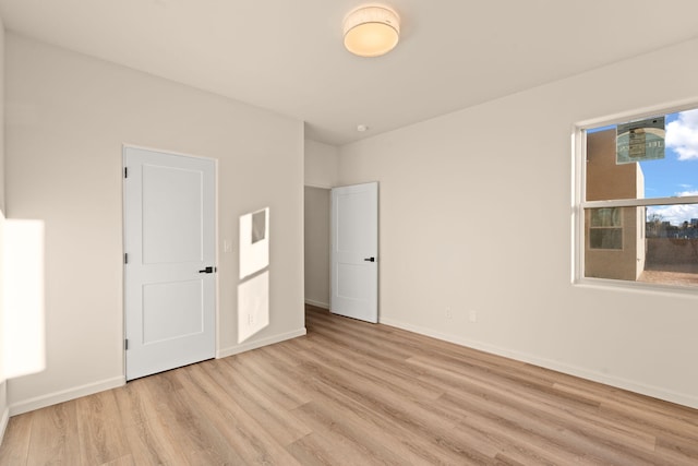 unfurnished bedroom featuring light wood-type flooring