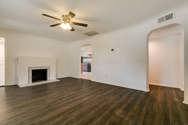 unfurnished living room featuring dark hardwood / wood-style flooring, sink, and ceiling fan