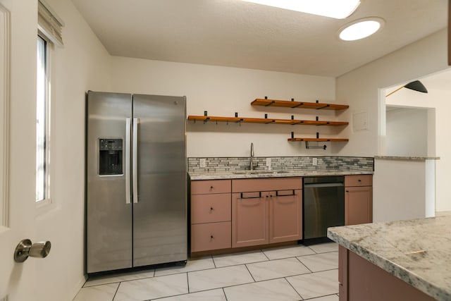 kitchen with sink, plenty of natural light, black dishwasher, tasteful backsplash, and stainless steel fridge with ice dispenser