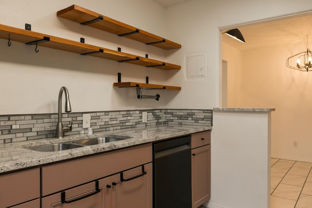 kitchen featuring sink, light stone counters, tasteful backsplash, a chandelier, and black dishwasher