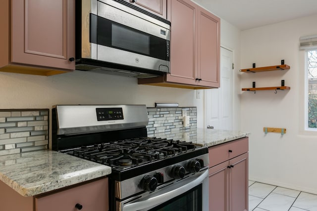 kitchen with tasteful backsplash, light stone countertops, and stainless steel appliances