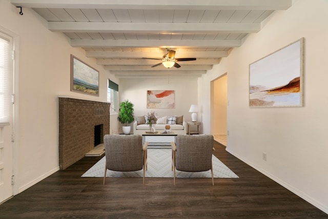 living room featuring a brick fireplace, dark hardwood / wood-style floors, and beam ceiling