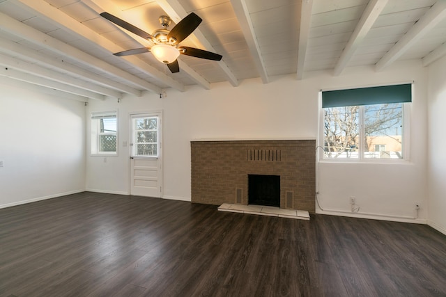 unfurnished living room featuring ceiling fan, a fireplace, dark hardwood / wood-style flooring, and beam ceiling