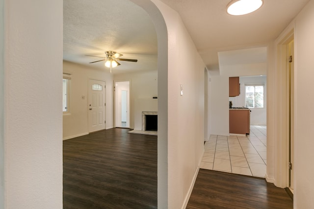 hall featuring wood-type flooring and a textured ceiling