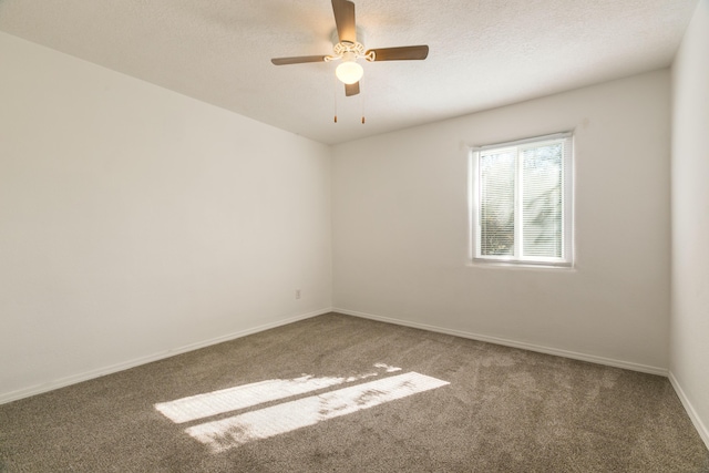 carpeted empty room with ceiling fan and a textured ceiling