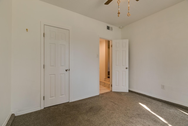 unfurnished bedroom featuring carpet flooring and ensuite bath