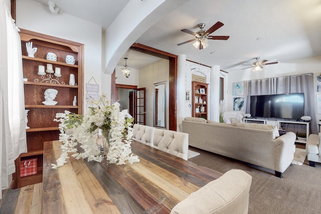 dining room featuring hardwood / wood-style floors, built in features, and ceiling fan