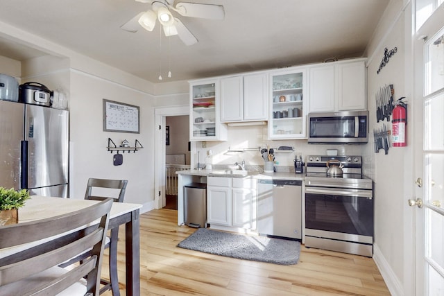 kitchen with white cabinetry, light hardwood / wood-style flooring, and stainless steel appliances