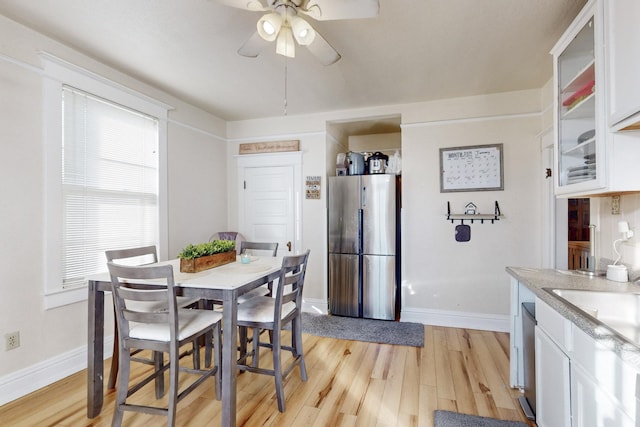 dining area featuring ceiling fan and light wood-type flooring