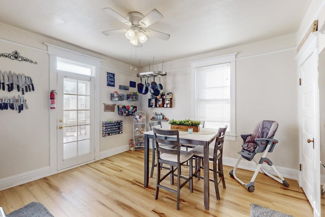 dining room with hardwood / wood-style flooring and ceiling fan