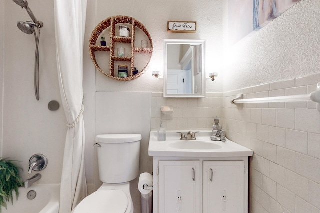 full bathroom featuring vanity, tile walls, shower / bath combination with curtain, and toilet