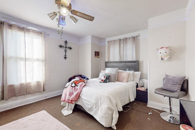 bedroom featuring ceiling fan and dark colored carpet