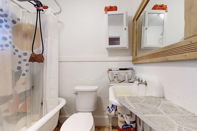 bathroom with shower / bath combination with curtain and toilet