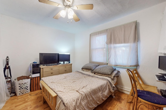 bedroom with ceiling fan and light wood-type flooring