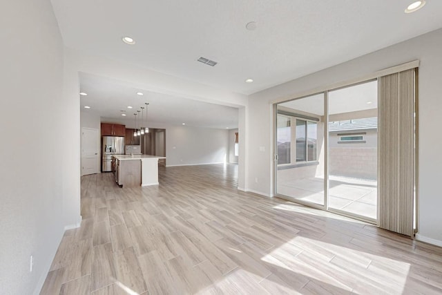 unfurnished living room featuring light hardwood / wood-style floors