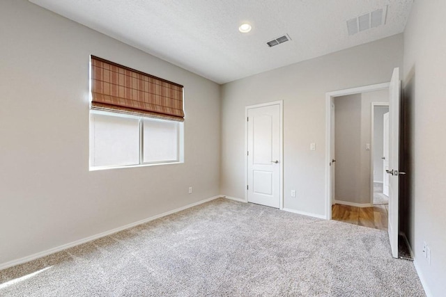 unfurnished bedroom with light colored carpet