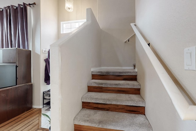 staircase featuring wood-type flooring