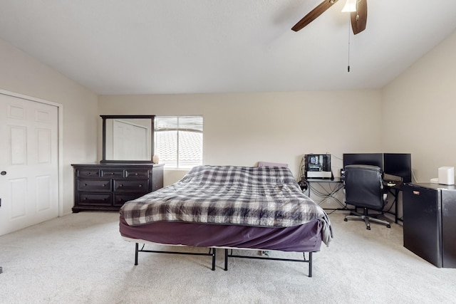 bedroom with light carpet, vaulted ceiling, and ceiling fan