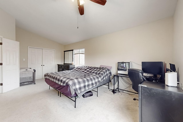 bedroom featuring lofted ceiling, light colored carpet, ceiling fan, and a closet