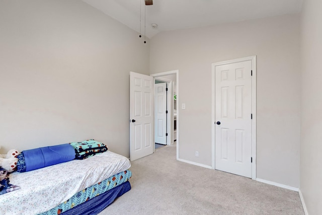 carpeted bedroom featuring ceiling fan and vaulted ceiling