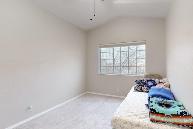 bedroom featuring lofted ceiling and carpet