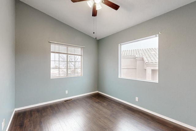 spare room featuring ceiling fan, dark hardwood / wood-style flooring, and vaulted ceiling