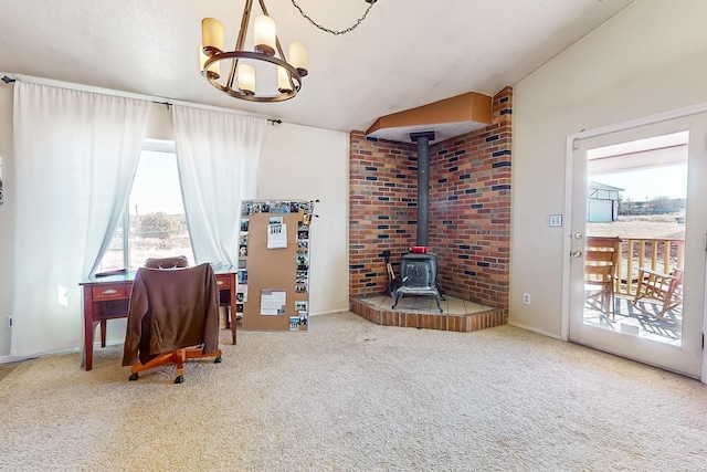 office featuring an inviting chandelier, vaulted ceiling, carpet, and a wood stove