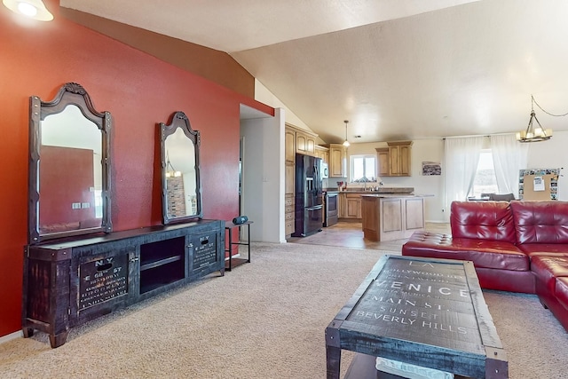 living room featuring lofted ceiling, light carpet, and a notable chandelier