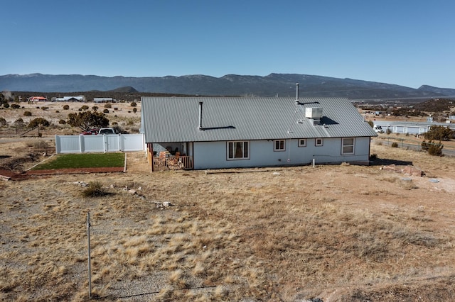 rear view of house featuring a mountain view