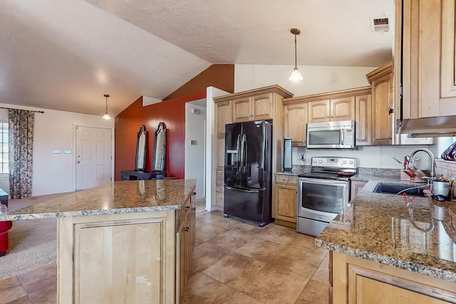 kitchen featuring sink, decorative light fixtures, a center island, and appliances with stainless steel finishes