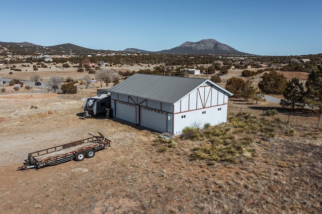 view of outbuilding with a mountain view and a garage