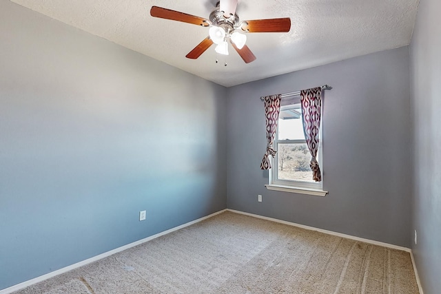 carpeted spare room featuring ceiling fan and a textured ceiling