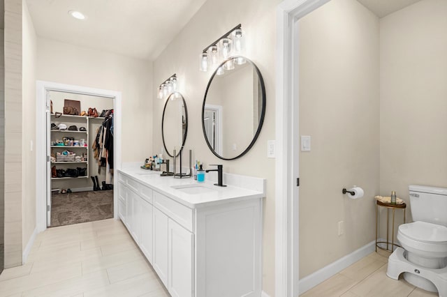 bathroom with vanity, tile patterned floors, and toilet