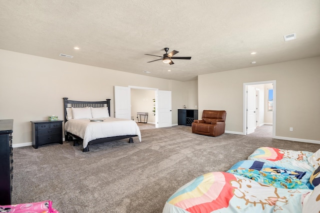 bedroom featuring ceiling fan, carpet flooring, and a textured ceiling