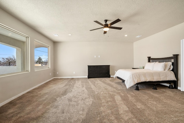 unfurnished bedroom featuring carpet, a textured ceiling, and ceiling fan