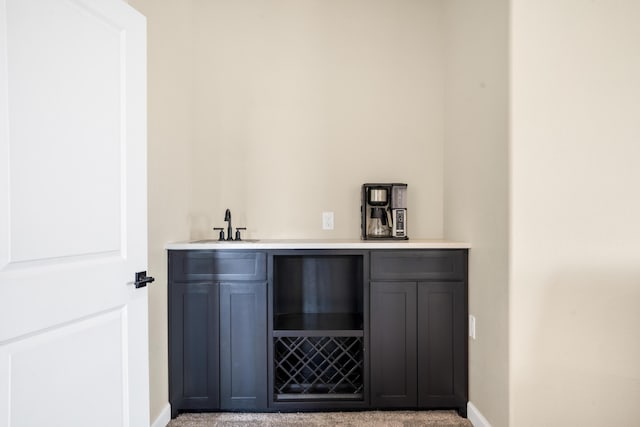 bar featuring sink and light colored carpet