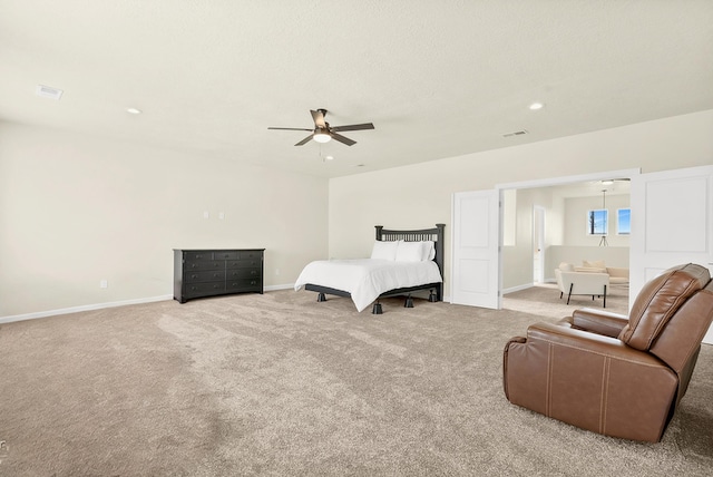 bedroom with light carpet, a textured ceiling, and ceiling fan