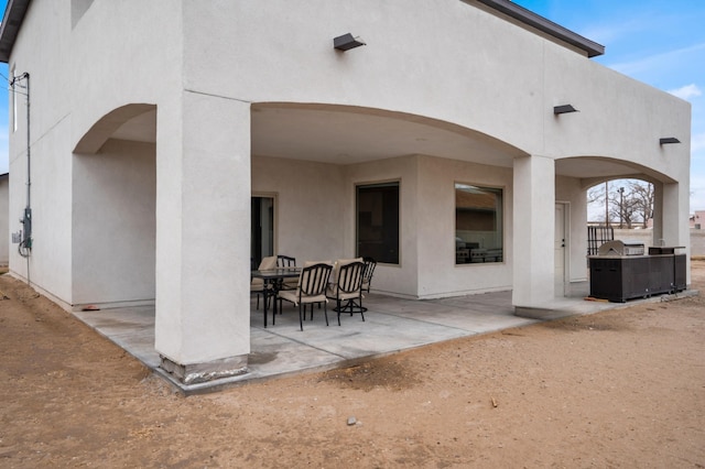 rear view of property featuring a patio area