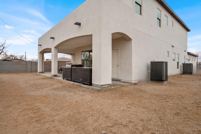 back of house with central AC unit and a patio area