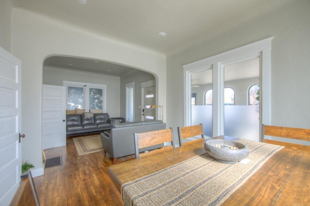 dining space with dark hardwood / wood-style flooring