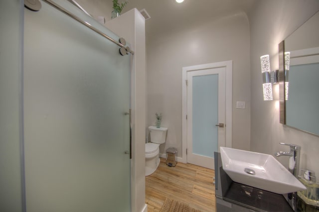 bathroom featuring hardwood / wood-style flooring, toilet, and sink