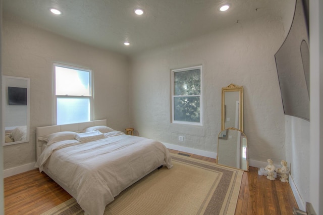 bedroom with hardwood / wood-style floors