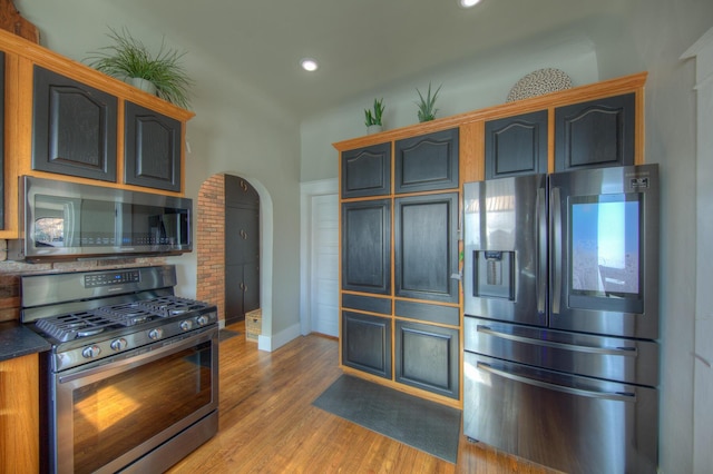 kitchen featuring hardwood / wood-style flooring and appliances with stainless steel finishes