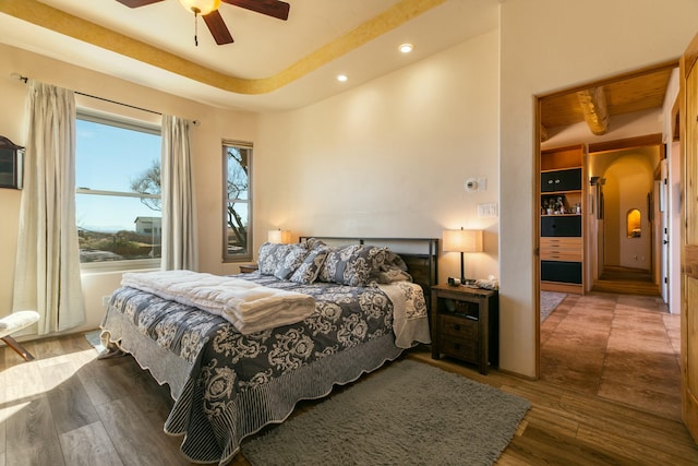 6816 Nagoya Rd NE, Rio Rancho, NM 87144 - bedroom with ceiling fan, a tray ceiling, and hardwood / wood-style floors
