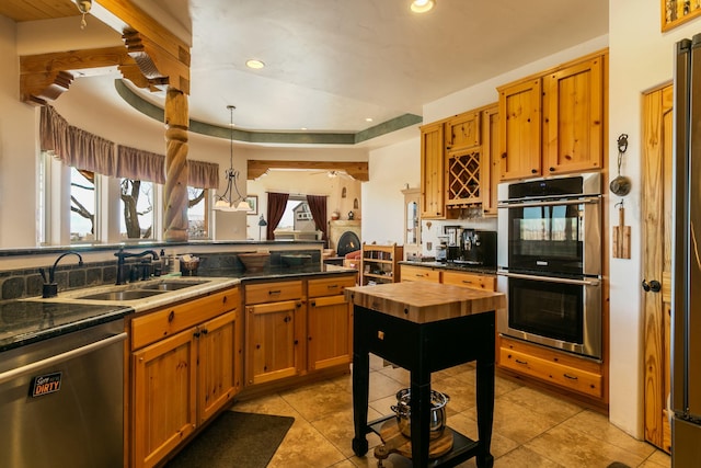 6816 Nagoya Rd NE, Rio Rancho, NM 87144 - kitchen featuring pendant lighting, sink, stainless steel appliances, light tile patterned flooring, and a raised ceiling